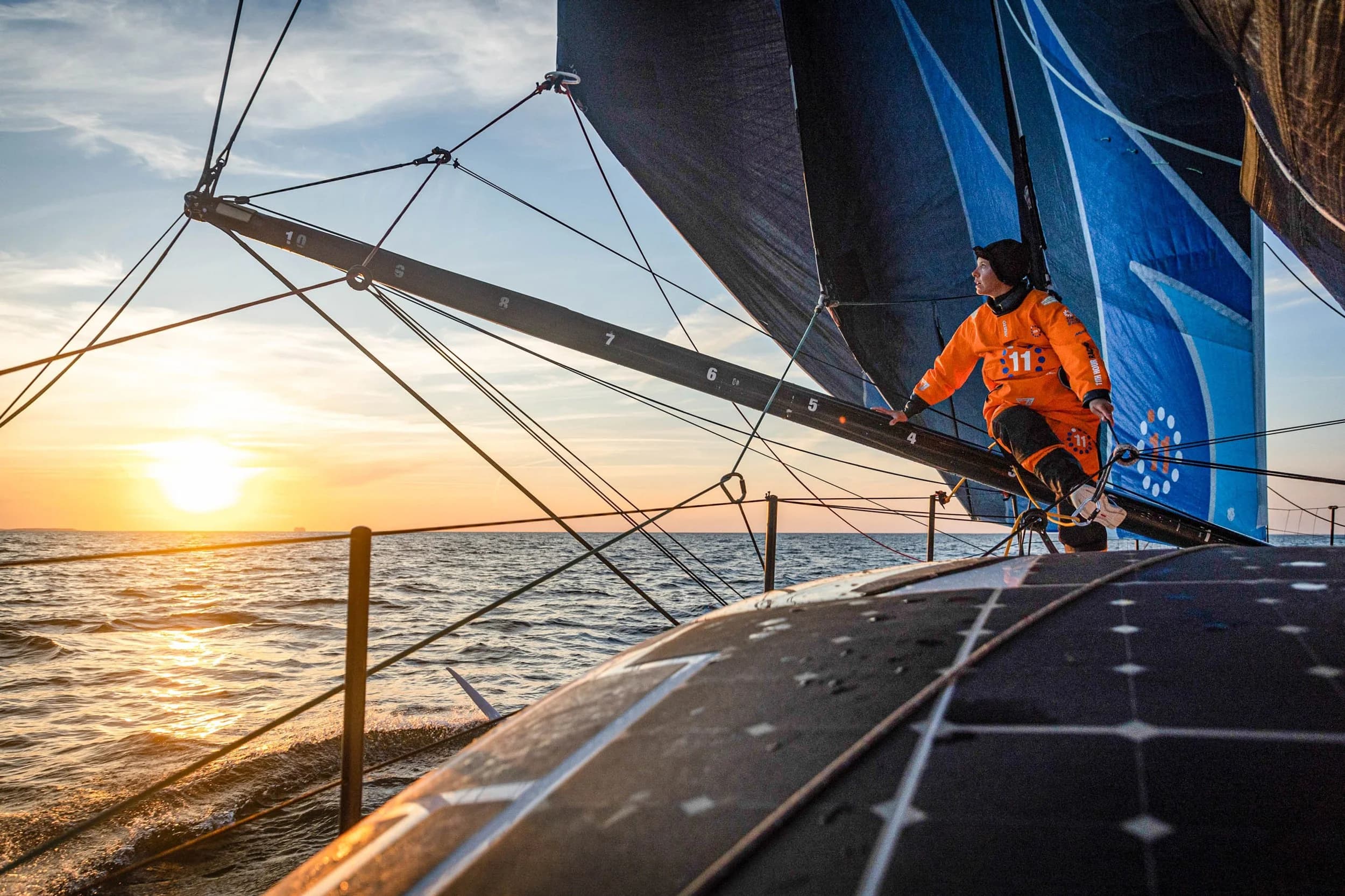 Racing yacht heeling through open ocean under sail